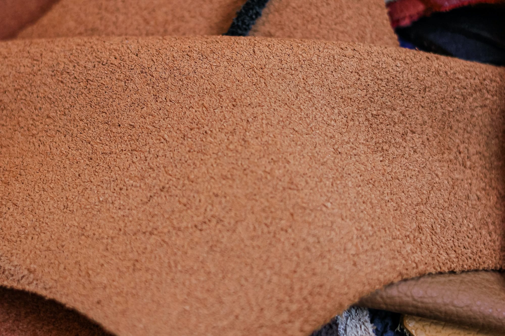 Natural brown suede leather background. Closeup. Selective focus.